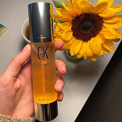 GK HAIR oil serum on glossy, nourished curls.