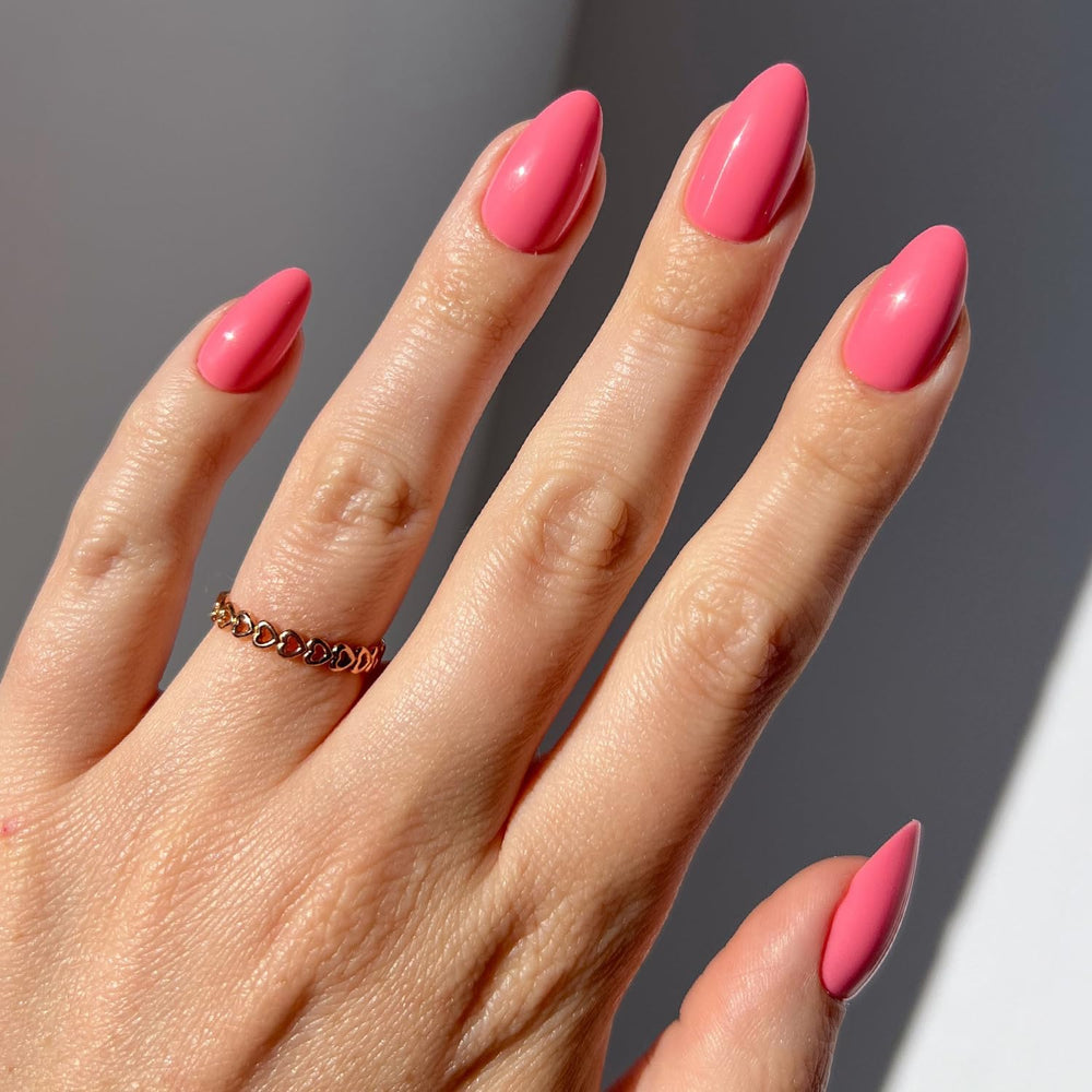 Glamnetic flamingo-pink nails close-up showing vibrant opaque pink color for everyday wear