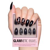 Glamnetic Love Me Not nails closeup with glossy black heart accents for bold style