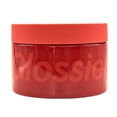 Glossier Creme de You body butter tub closeup showing rich, fast-absorbing texture.