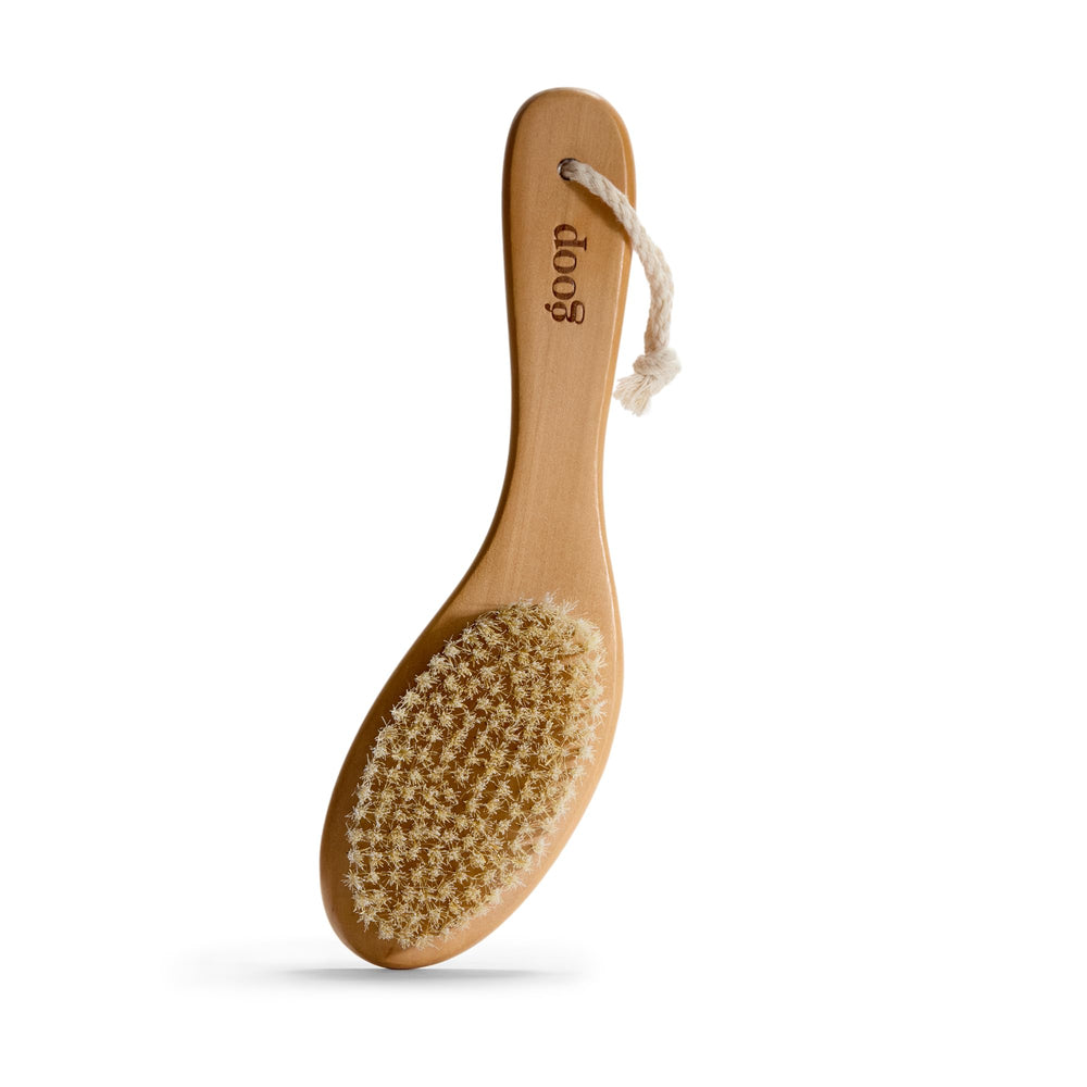 goop Beauty Dry Brush with wooden handle for smoother skin exfoliation.