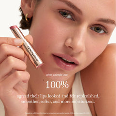 goop Beauty tinted lip balm tube closeup for portable, all-day lip hydration.