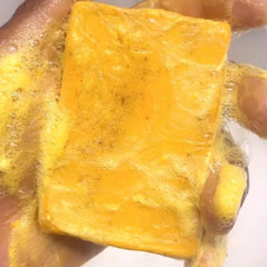 Guluxly Lemon Turmeric Soap being used on body in shower scene for cleansing