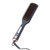 Hairitage heated ceramic straightening brush in use for a smooth blowout and frizz control.