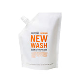 Hairstory New Wash Original bottle pours for a gentle cleanse across hair types.