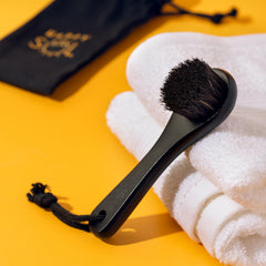 Happy Sol bristles on neck area illustrating gentle lymphatic brushing.