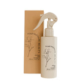 Harmonize Beauty leave-in conditioner bottle demonstrates frizz control for smooth styling.