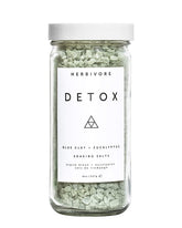 HERBIVORE Detox Soaking Salts bottle pour for a soothing spa-like bath ritual.