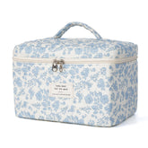 Honitty makeup bag with a quilted floral pattern keeps cosmetics organized on the go.