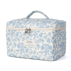 Honitty makeup bag with a quilted floral pattern keeps cosmetics organized on the go.