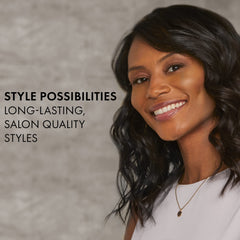 HOT TOOLS Pro Artist Black Gold Ionic flat iron in hand for versatile straight and curled styles.