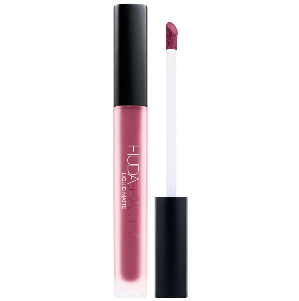 Huda Beauty Trophy Wife liquid matte lipstick swatches showcase the rose wood shade for versatile daytime looks.