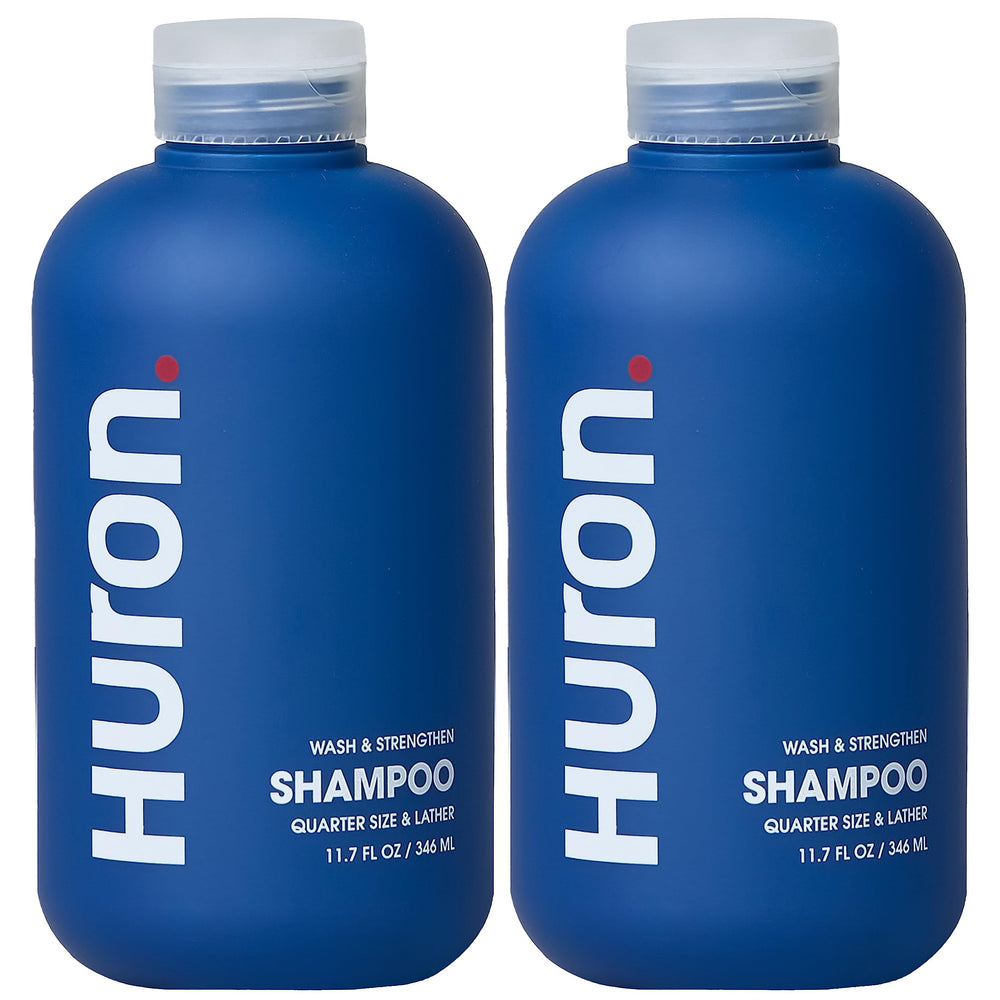 Huron Clean Citrus Woods shampoo bottle with invigorating citrus scent for daily refreshment