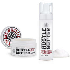 Hustle Butter Deluxe tattoo wash bottle closeup shows antibacterial formula for clean healing