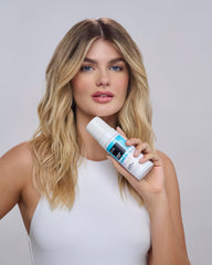 IGK Beach Club Texture Foam being scrunched into damp hair for texture.