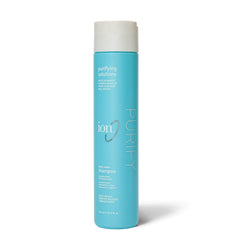 Ion Purifying Solutions shampoo bottle on sink for refreshed hair after hard water exposure