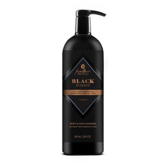 Jack Black Black Reserve Cleanser bottle pour showing cardamom-cedarwood aroma for balanced cleansing.