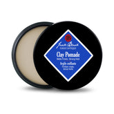 Jack Black Clay Pomade jar cap shows natural matte finish for textured styling.