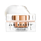 JLO BEAUTY under-eye cream tube closeup showing hydrating formula.