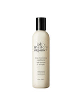 John Masters Organics Deep Moisturizing Conditioner bottle pour demonstrates silicone-free hydration.