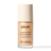 Jouer Luminizing Glow Drops bottle close-up showing hydrating formula for dewy skin.