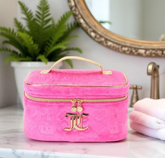 Juicy Couture hot pink makeup bag velour texture detail elevates luxury look.