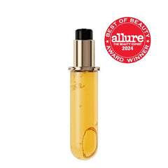 KÉRASTASE Elixir Ultime oil pump demonstrates easy application to mid-lengths.