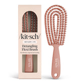 Kitsch Detangler Brush with bendable frame gliding through tangles for gentle detangling.