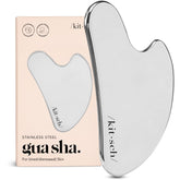 Kitsch stainless steel gua sha tool close-up on cheek for precise facial massage