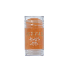 Kopari Sun Shield On-The-Glow stick gliding on the face for UV protection