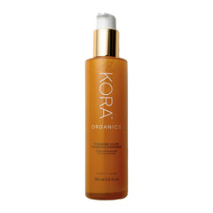 KORA Organics Turmeric Glow Foaming Cleanser bottle ready for radiant skin prep