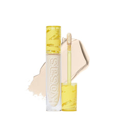 Kosas Revealer Concealer tube closeup shows creamy medium coverage for a natural finish.