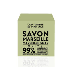 La Compagnie de Provence Savon Marseille Olive Soap Cube in-use hand for gentle cleansing.
