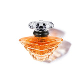 Lancôme Trésor bottle with crystal pyramid conveys lasting elegance for romantic evenings.
