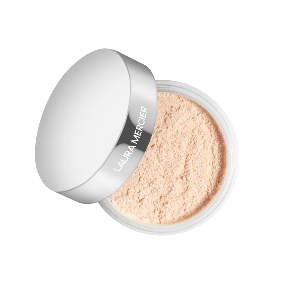 Laura Mercier Light Catcher powder compact close-up for a luminous, long wear finish.