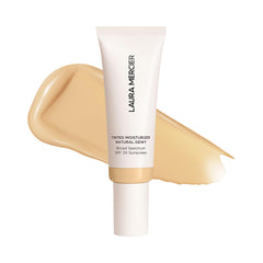 Laura Mercier Tinted Moisturizer Blonde bottle offers lightweight hydration for dewy skin.
