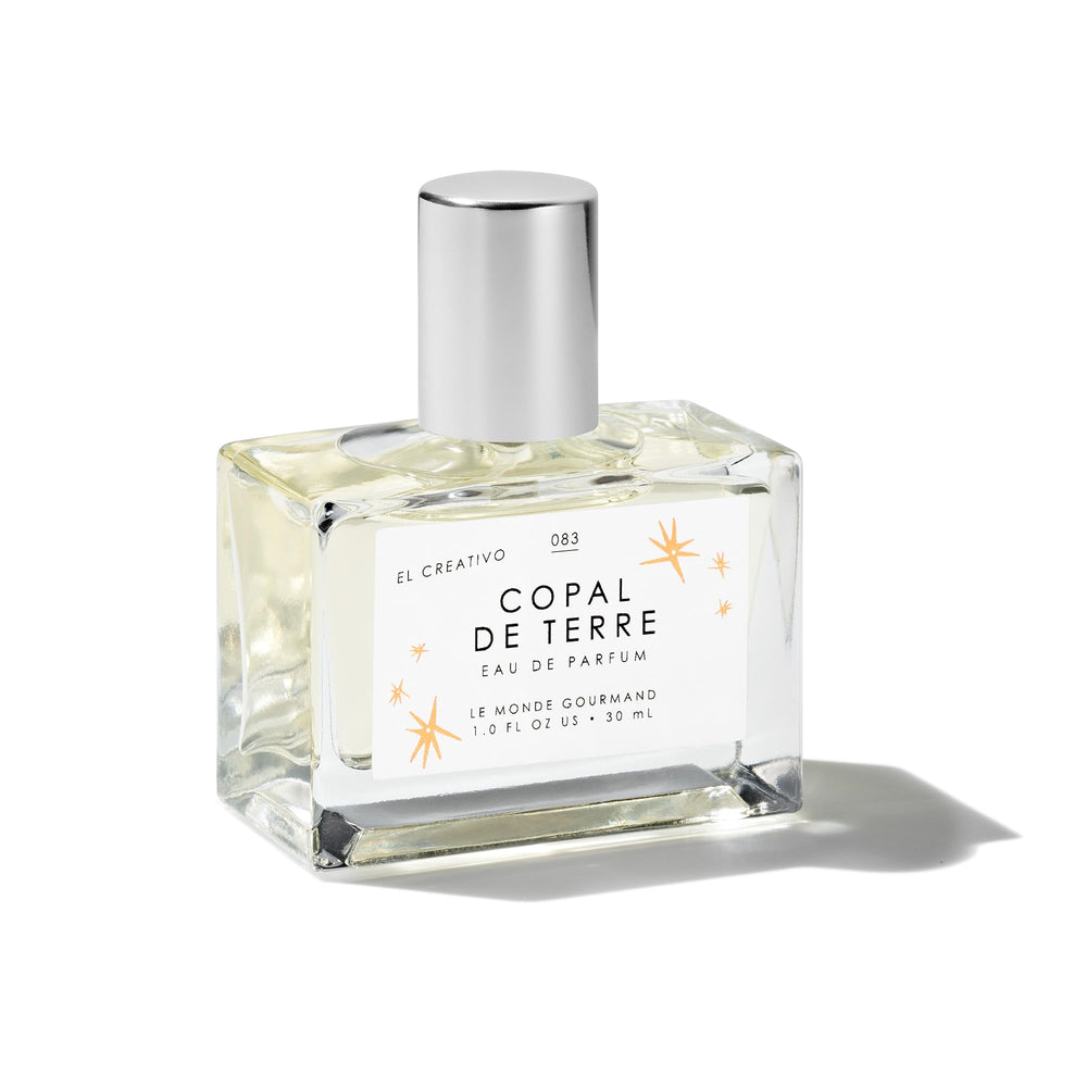 Le Monde Gourmand Copal de Terre bottle close-up with amber glow for daily fragrance ritual.