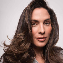 Living proof Full Volume Root-Lifting Spray on hair showing styled look with shine.