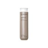 Living Proof No Frizz Conditioner bottle pouring to highlight frizz control benefits