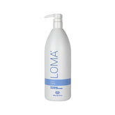 Loma Calming Crème bottle pump demonstrates easy, mess-free application for smooth, frizz-free hair.