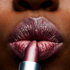 MAC Frost Lipstick Plum Dandy swatch on skin showing buildable color and glow.