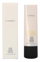 MAC Strobe Cream Goldlite bottle under soft lighting delivers a dewy, radiant base.