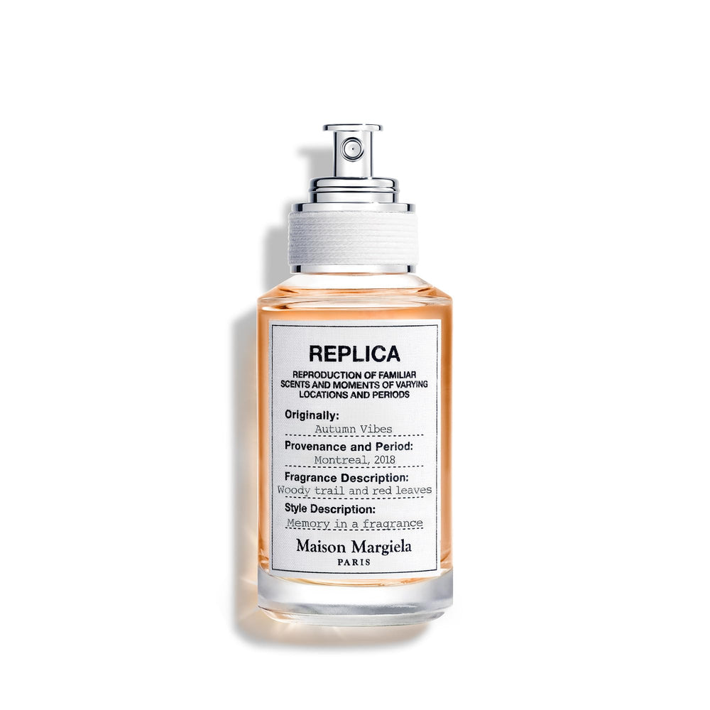 Maison Margiela Replica Autumn Vibes bottle on a warm surface, signaling timeless elegance for daily fragrance routines.