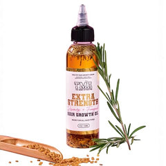 The Mane Attraction extra-strength rosemary-fenugreek oil bottle label highlights natural ingredients for scalp care.