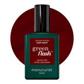 Manucurist Green Flash Dark Pansy bottle closeup, vegan plant-based gel polish for burgundy nails.