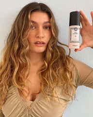 Maria Nila Cream Heat Spray hand-application scene suggests even distribution and protection.