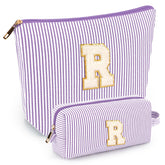 Mibasies initial makeup bags in purple, front view, ideal for organized travel.