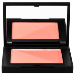 NARS Deep Throat swatch on cheek reveals soft pink-peach glow