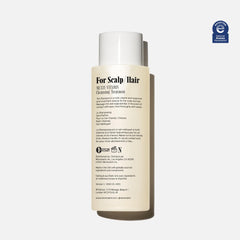 Nécessaire The Shampoo pump-action close-up showcasing gentle cleansing in daily routine.