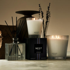 Lavender sprig beside NEST New York Cedar Leaf & Lavender soap.
